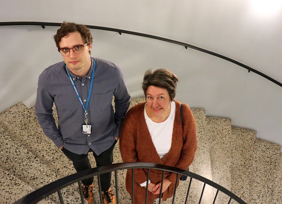 Researchers Jaakko Hyytiä and Paula Kuusipalo in a stairwell.