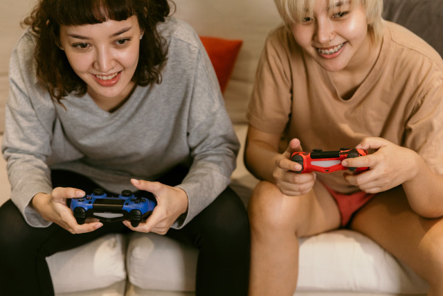 Stock photo of two young people playing a video game.